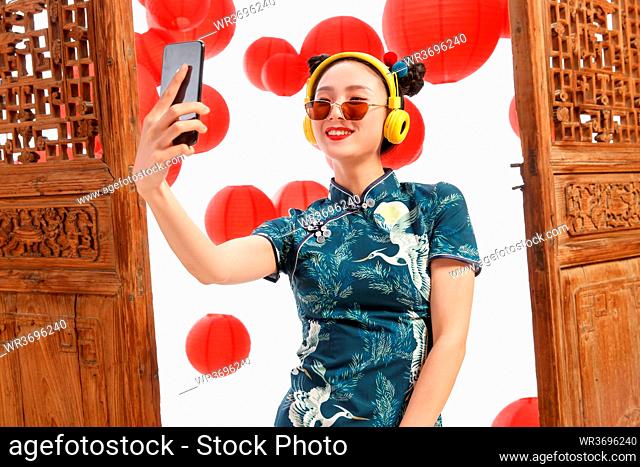 Happy woman with a cell phone camera