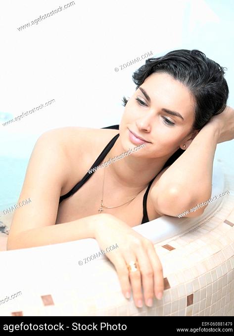Young women is daydreaming in the bathtub
