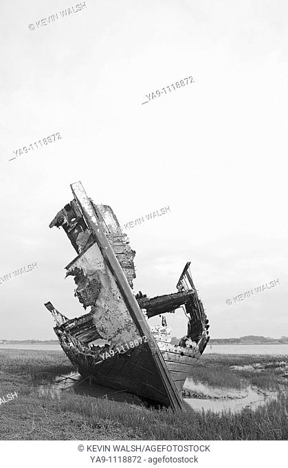 Rotting fishing boat on the sandbanks of the River Wyre estuary in Lancashire, England, UK