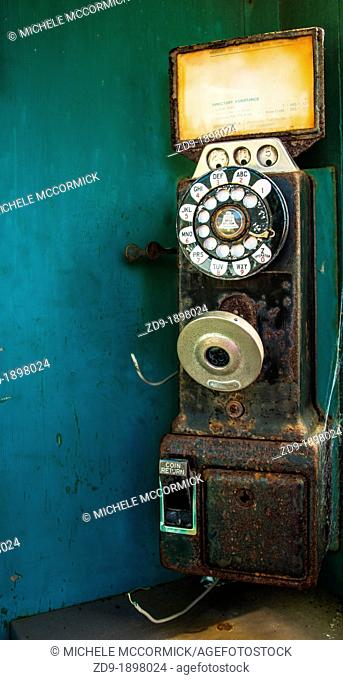 A classic pay phone rusts and deteriorates on a dock in California's Bodega Bay