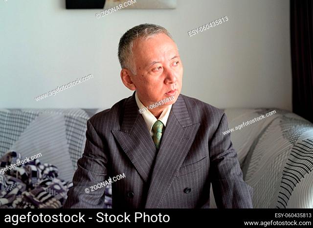 Portrait of mature Japanese businessman staying at home under quarantine for corona virus covid-19 pandemic