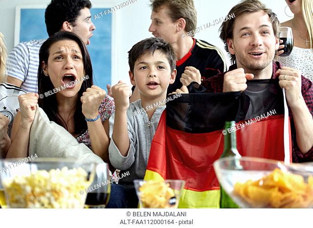 German football supporters watching match at home