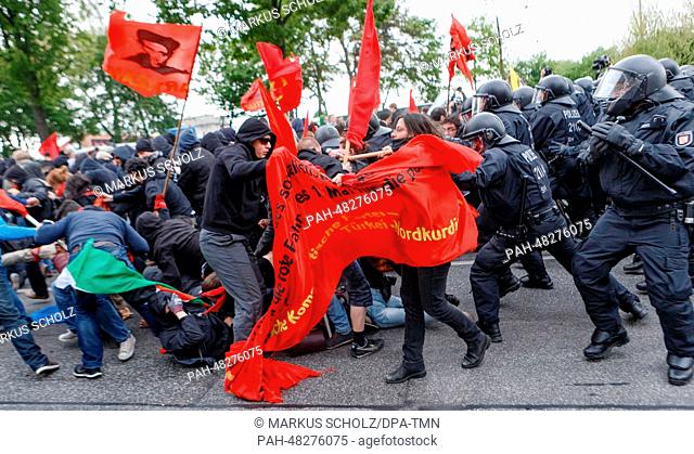 Police officers stop demonstrators and force them onto a shortened route during the May Day demonstration in Hamburg, Germany, 01 May 2014