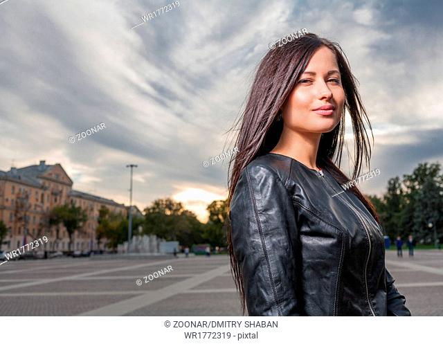 russian brunette 20s years old posing outdoors weared black leather jacket