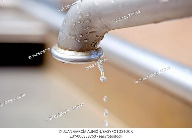 Water drops flowing from metal clean water tap