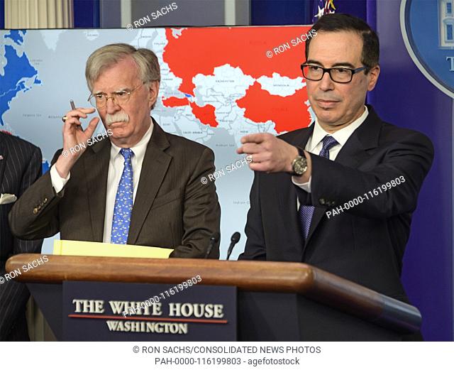 United States Secretary of the Treasury Steven T. Mnunchin, right, conducts a briefing with National Security Advisor John R