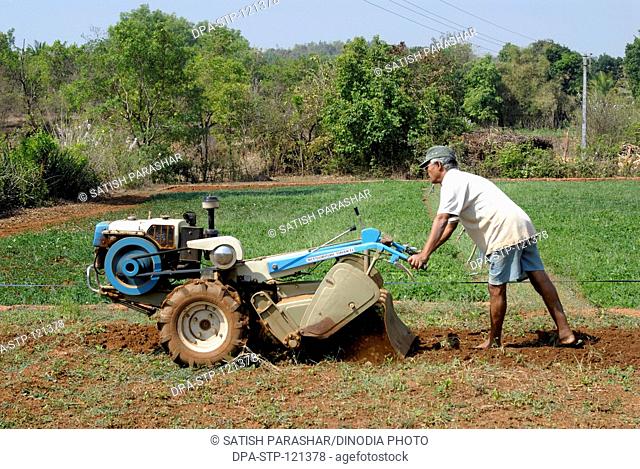 A farmer and the instructor in field with Powertiler village ; taluka Lanja ; district Ratnagiri ;  Maharashtra ; India ; Asia