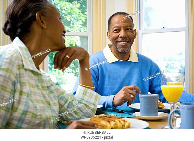 Senior man and a senior woman sitting at the breakfast table