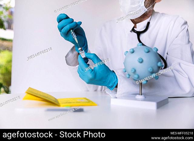 Doctor preparing injection with Corona virus vaccine