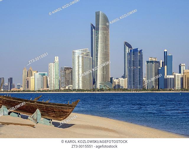 Traditional boat in the Heritage Village with city skyline in the background, Abu Dhabi, United Arab Emirates
