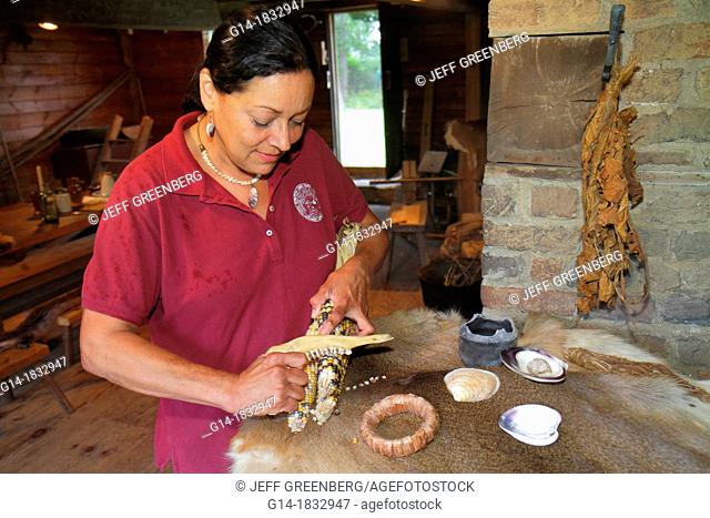 Massachusetts, Cape Cod, Bourne, Aptucxet Trading Post Museum, Wampanoag Native American, woman, Indian, demonstrating, corn, animal jaw, historical society