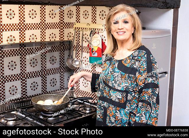 The Italian singer and TV presenter Iva Zanicchi prepares and cooks the gnocco fritto, a traditional dish of Emilian gastronomy