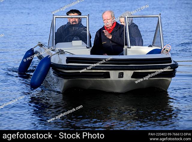 29 March 2022, Berlin: Ronald Jurok, a driving instructor for boating licenses, drives a small motorboat across the Havel River at Scharfe Lanke together with...
