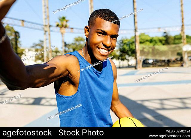Male basketball player gesturing at sports court