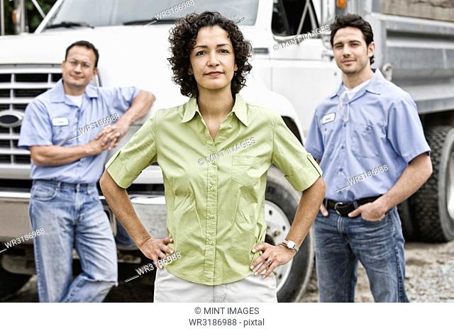 Mixed race team of workers at a landscape company with a woman in the lead