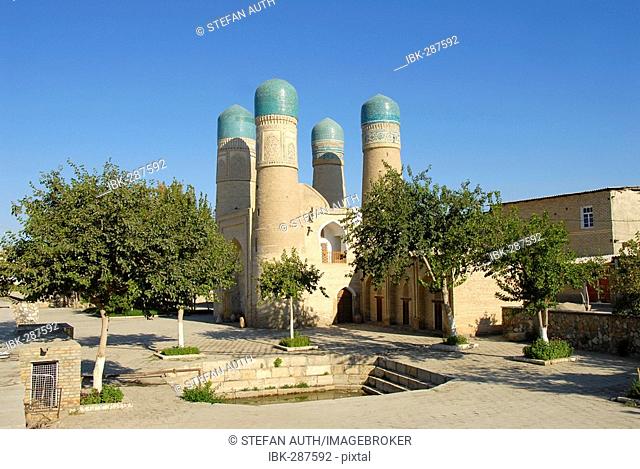 Four minarets Char Minar gatehouse behind trees Bukhara Uzbekistan