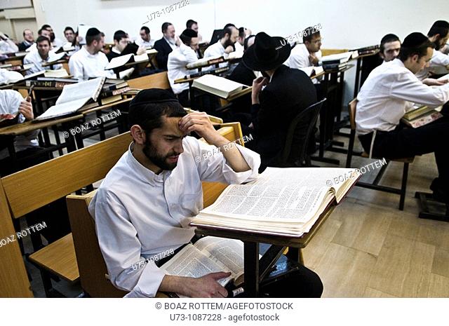 Orthodox men study the bible in a Yeshiva ( religious school ) in Jerusalem