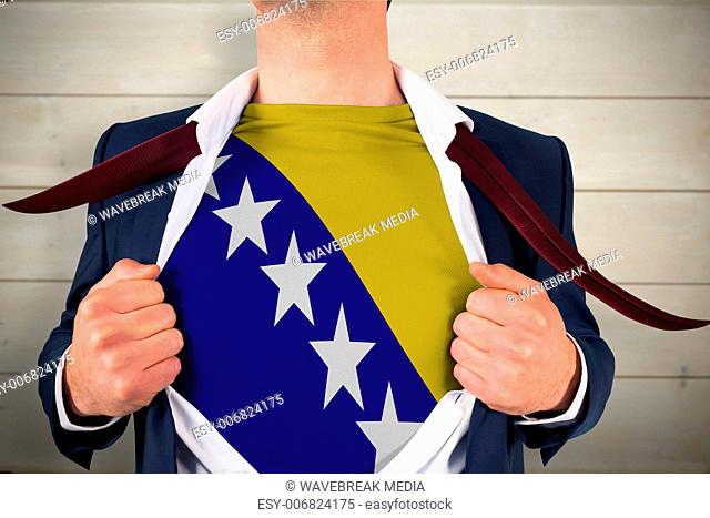 Composite image of businessman opening shirt to reveal bosnia flag
