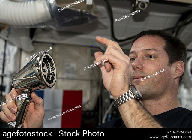Photo of European Space Agency (ESA) astronaut Thomas Pesquet working with the Ultrasonic Tweezers experiment setup and experiment scenario execution