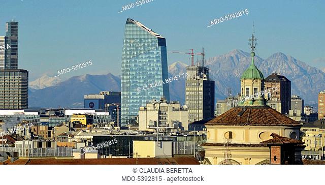 View of Milan from Milan Cathedral: Pirelli Tower, Diamond Tower and the dome of the Church of Saint Fidelis. In the background, the Alps