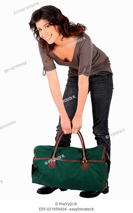 Woman lifting heavy bag