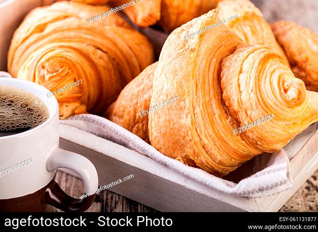 Fresh Croissants on wooden rustic background
