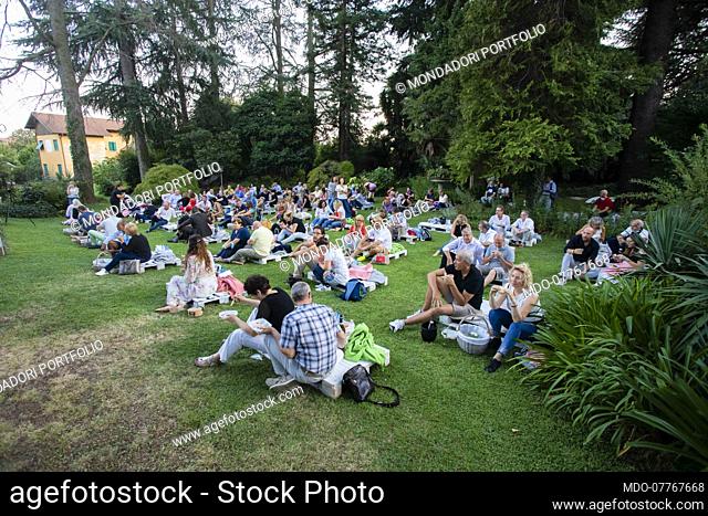 The audience sitting on pallets spaced out on the lawn of the Villa Zappa Bencini waiting for the first concert with Irene Grandi as part of the MUSICNIC music...