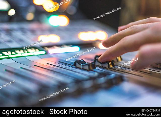 Professional music production in a sound recording studio. Sound engineer is working