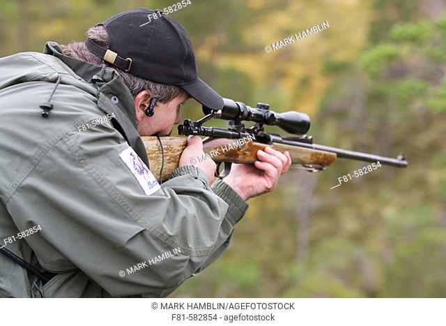 Hunter aiming rifle. Norway. September 2006