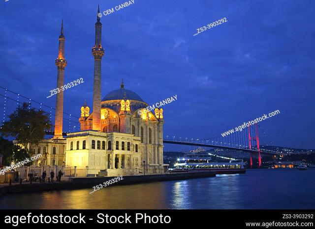 View to the Ortakoy Mosque or Buyuk Mecidiye Mosque on Bosphorus and to the Bosphorus bridge at the background by night, Ortakoy, Besiktas, Istanbul