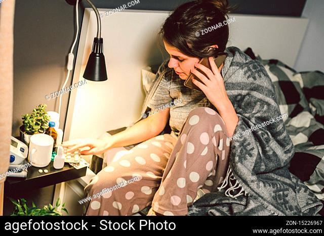 respiratory diseases and home remedies. young woman sick with cold sitting bedroom on bed holding throat sadness emotion. Sore throat man takes pills