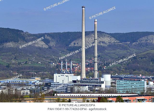 10 April 2019, Thuringia, Jena: The chimneys of the TEAG heating power plant in Jena are visible from afar. Here the demolition of the last large coal chimney...