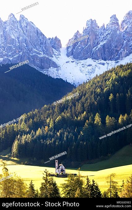 Saint John's Church in the Val di Funes surrounded by mountains