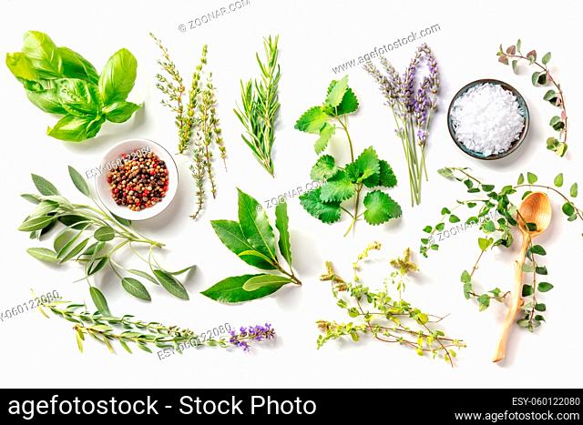 Fresh aromatic herbs, overhead flat lay shot on a white background with spices. Bunches of rosemary, basil, thyme and various other culinary plants