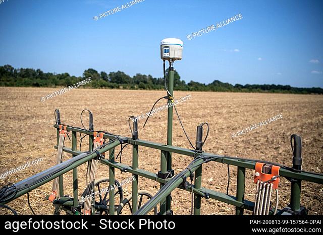 13 August 2020, Lower Saxony, Achim: A small tractor with measuring probes drives over a field. Using a geomagnetic measurement