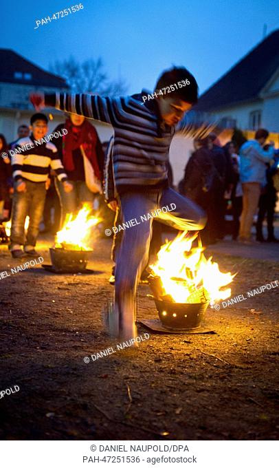 A child jumps over the Wednesday Light (Chaharshanbe Suri) during the Persian New Year's festival ""Nouruz"" celebrated by the Iranian community in Berlin