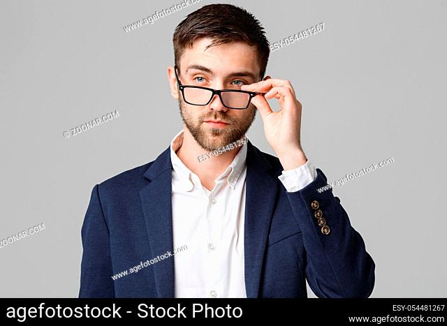 Business Concept - Portrait of a handsome businessman in suit with glasses serious thinking with stressful facial expression