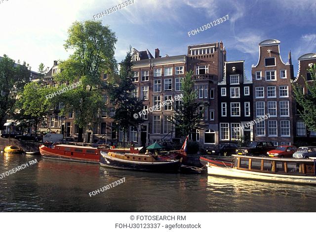 Amsterdam, Holland, Netherlands, Noord-Holland, Europe, Houseboats docked along a canal in Amsterdam
