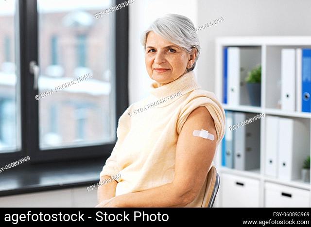 vaccinated woman with medical patch on arm