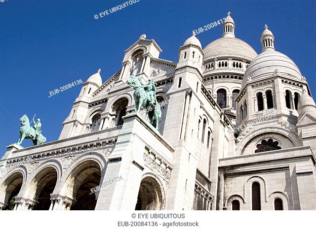 Montmartre The facade of the church of Sacre Couer with the bronze equestrian statues of Saint Louis and Joan of Arc by H Levebure