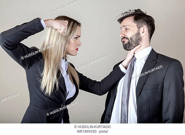 Business woman strangling a business man