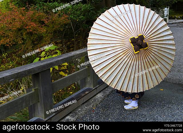 Young boy with an umbrella in Ise jinju, Honshu, Japan, Asia