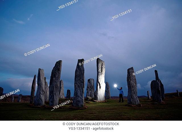 Callanish standing stones lit by light at night, Isle of Lewis, Western Isles, Scotland