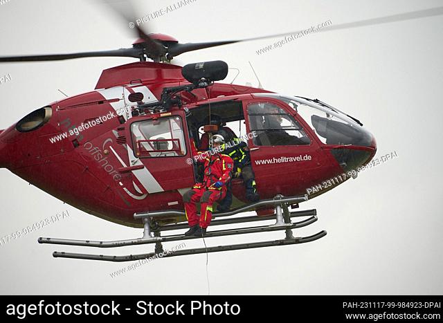 17 November 2023, Rhineland-Palatinate, Winningen: An Airbus H 145 helicopter picks up people with a crew from the Rhineland-Palatinate police helicopter...