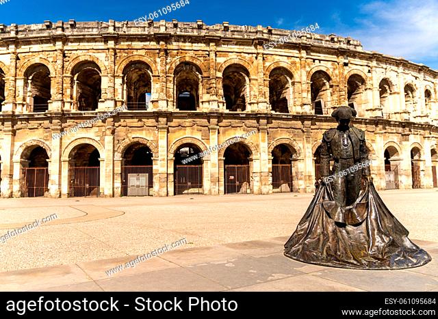 Nimes, France - 15 March, 2021: view of the Roman amphitheater in Nimes with the statue of the bullfighter Nimeno