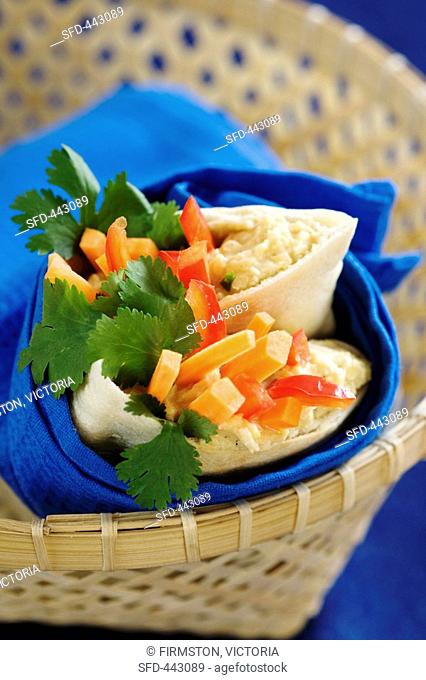 Pita bread filled with hummus, vegetables and coriander