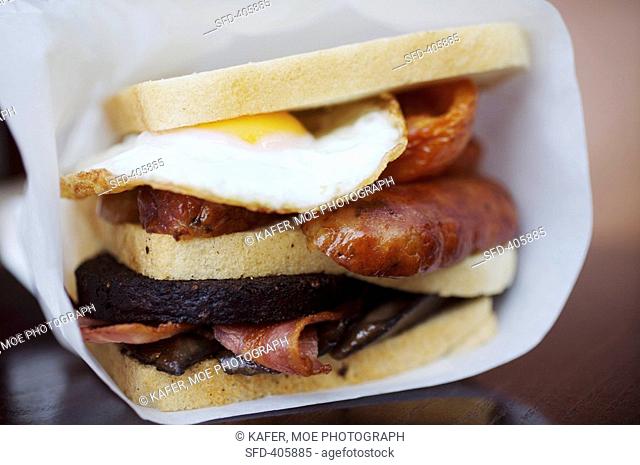 English breakfast sandwich: fried egg, black pudding etc