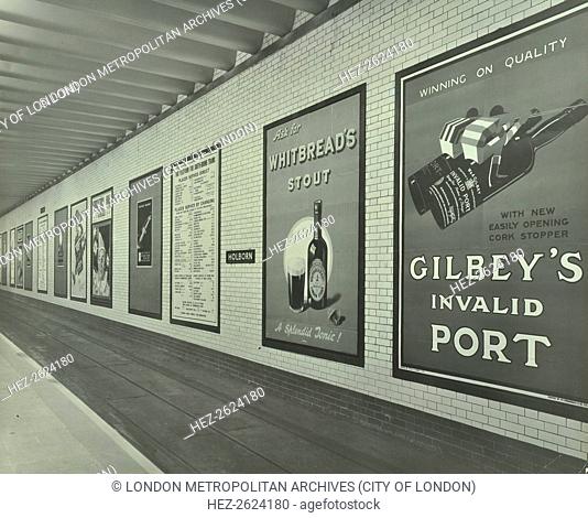 Advertisements for beer and port, Holborn Underground Tram Station, London, 1931. Advertising posters on the south-bound platform at Holborn Underground Tram...
