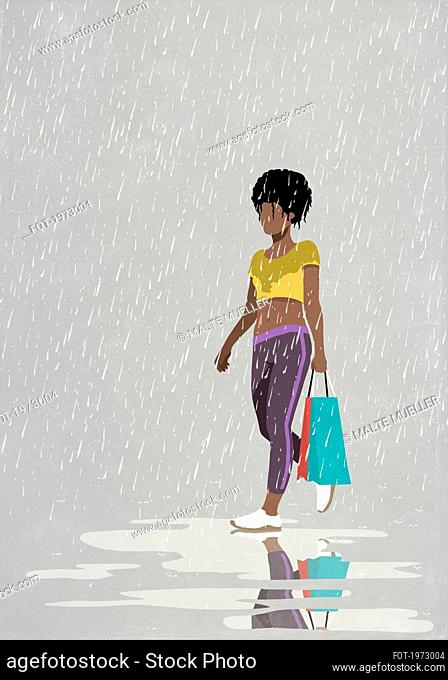 Woman with shopping bag walking in rain