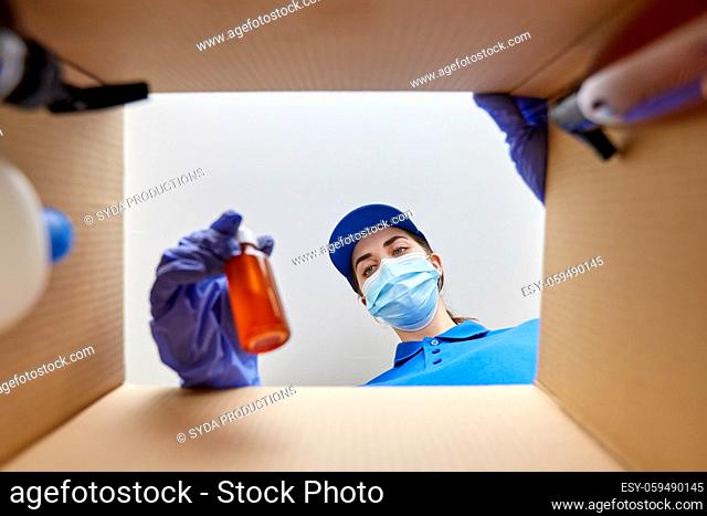 woman in mask packing parcel box with cosmetics